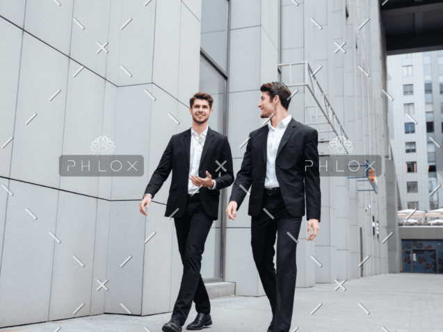 demo-attachment-922-two-businessmen-walking-and-talking-in-the-city-PMW8E26